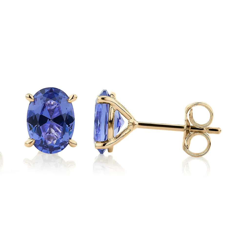 Oval stud earrings with tanzanite simulants in 10 carat yellow gold